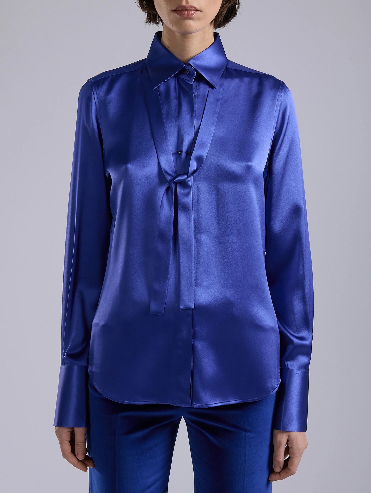 Blue silk blouse, piercing